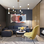 Modern living room with a blue sofa, yellow chair, and abstract art on the wall.