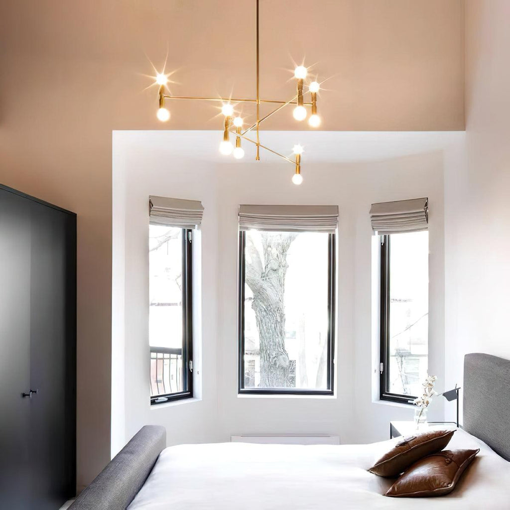 Modern bedroom with a chandelier, bed, and large windows.