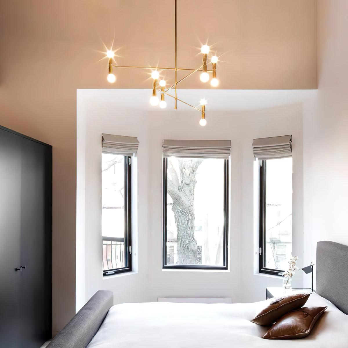 Modern bedroom with a chandelier, bed, and large windows.