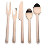 Set of rose gold cutlery on a white background