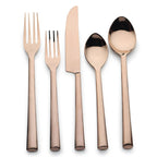 Set of rose gold cutlery including fork, knife, and spoons on a white background
