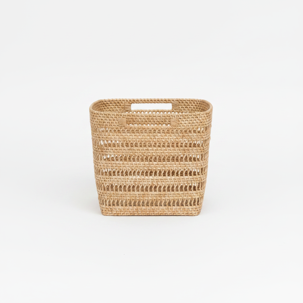 Woven storage rattan basket with handles on a white background