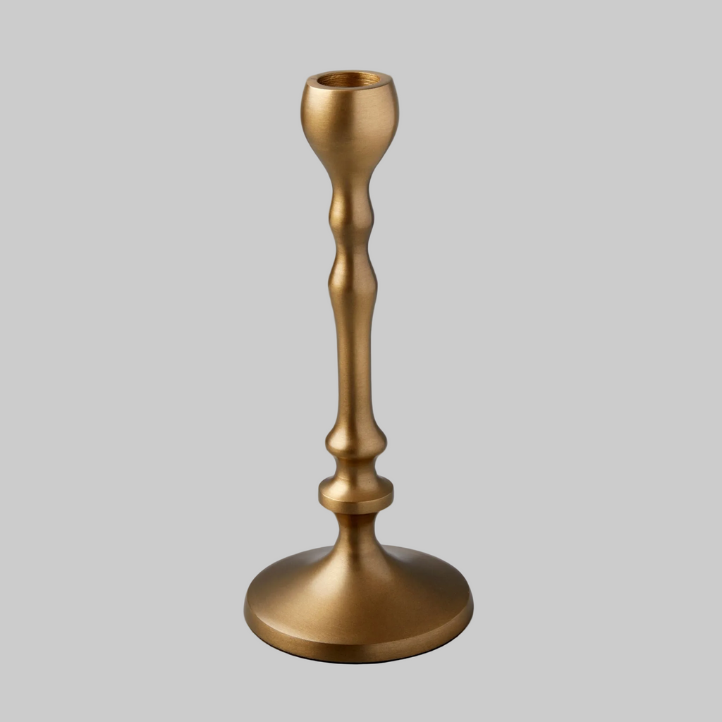 Gold candle holder on a gray background