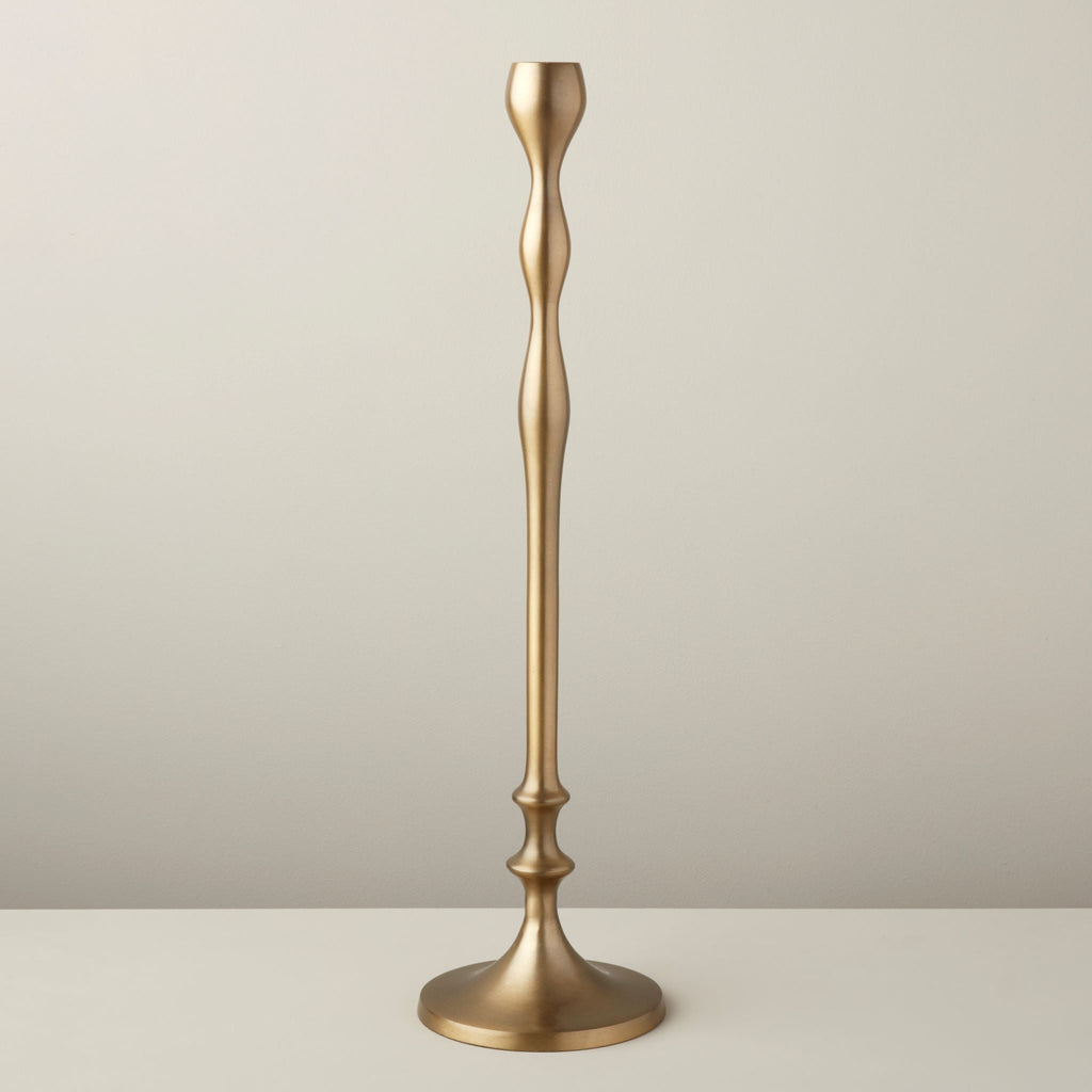 Gold candlestick on a neutral background