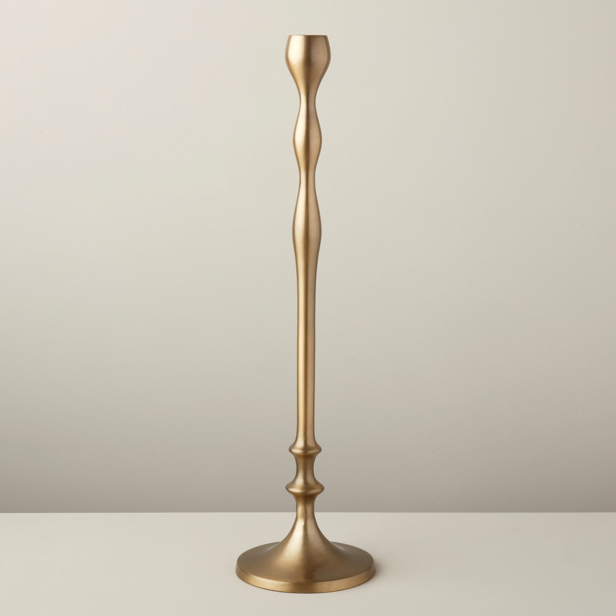 Gold candlestick on a neutral background