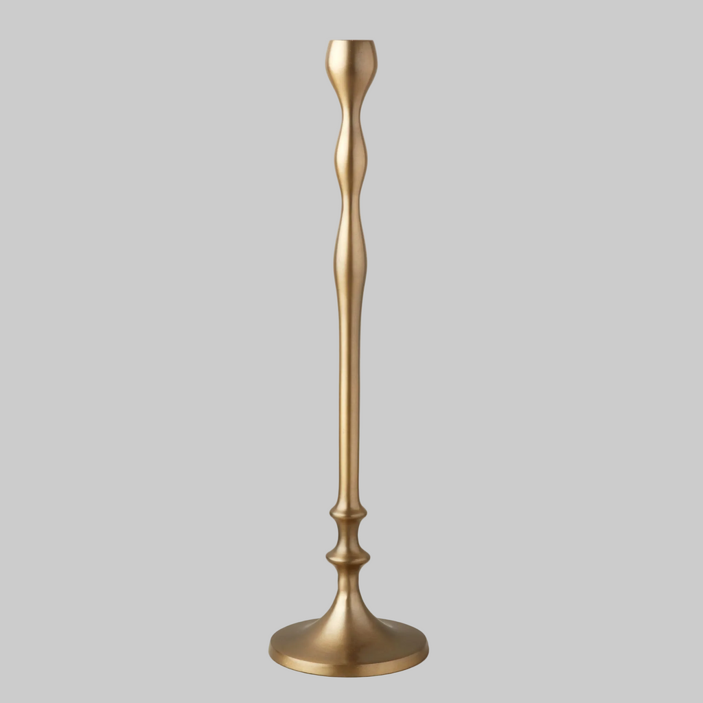 Gold candle holder on a gray background