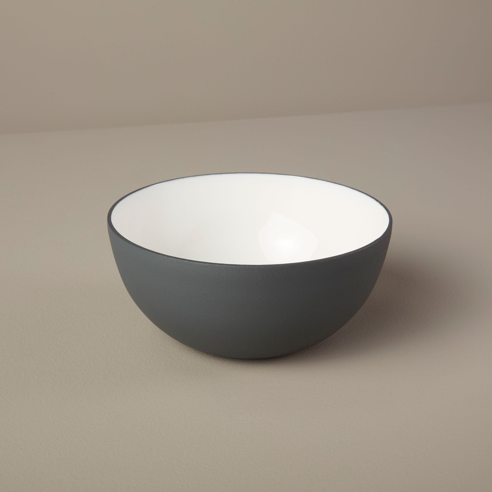 Gray bowl on a beige background
