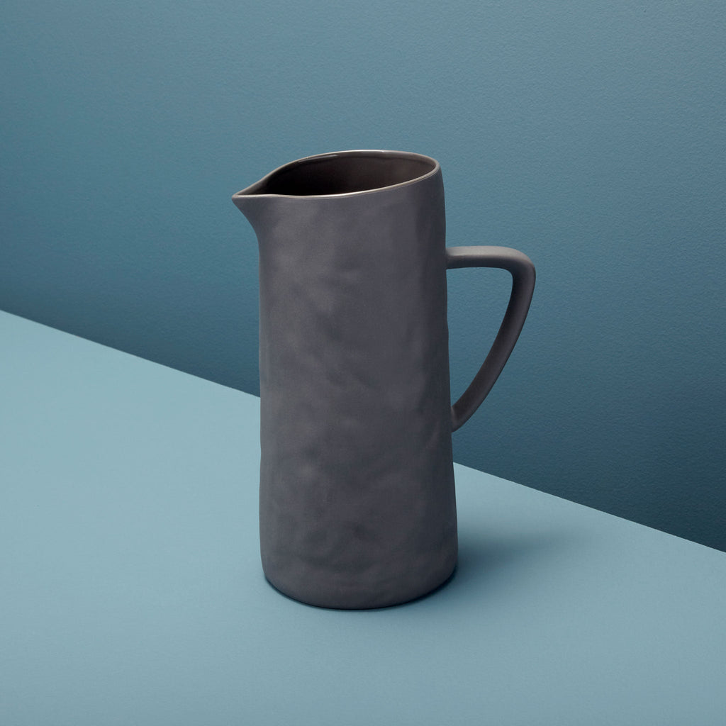 Gray pitcher on a two-tone blue background