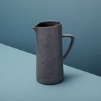 Gray pitcher on a two-tone blue background