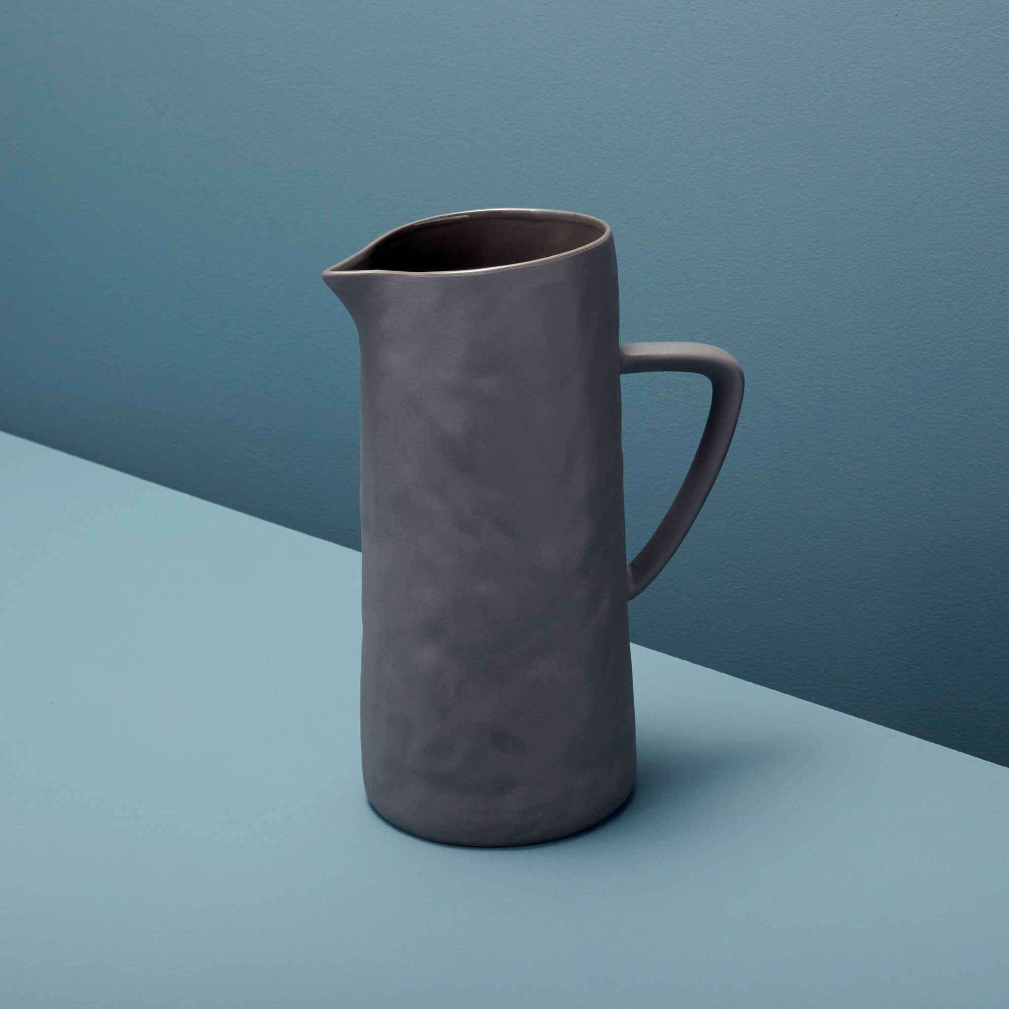 Gray pitcher on a two-tone blue background