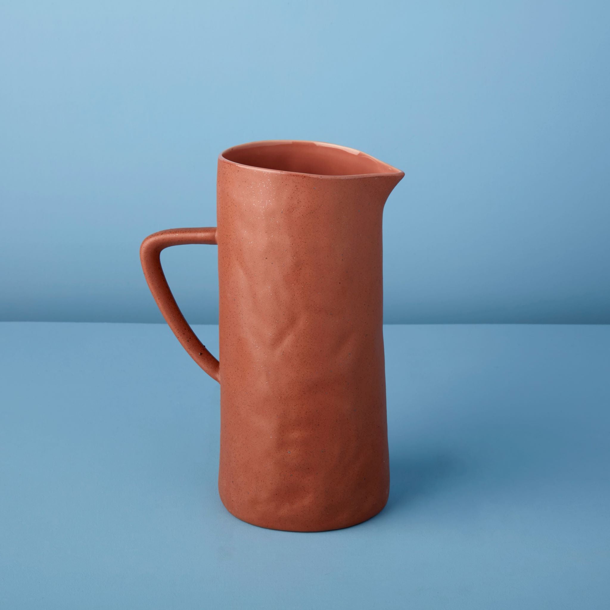 Terracotta pitcher on a blue background