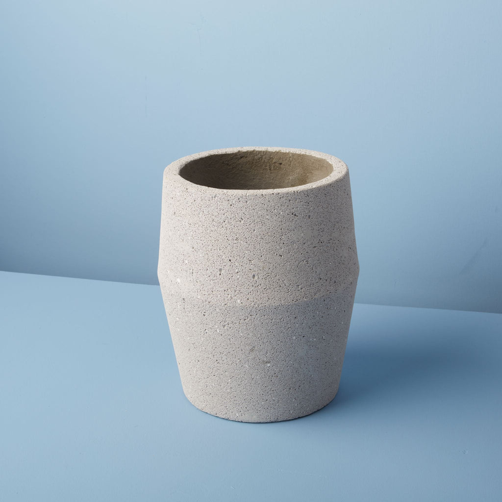 Textured ceramic pot on a blue background