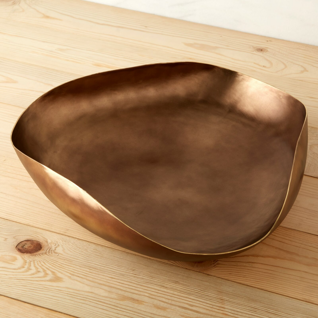 Bronze bowl on a wooden surface