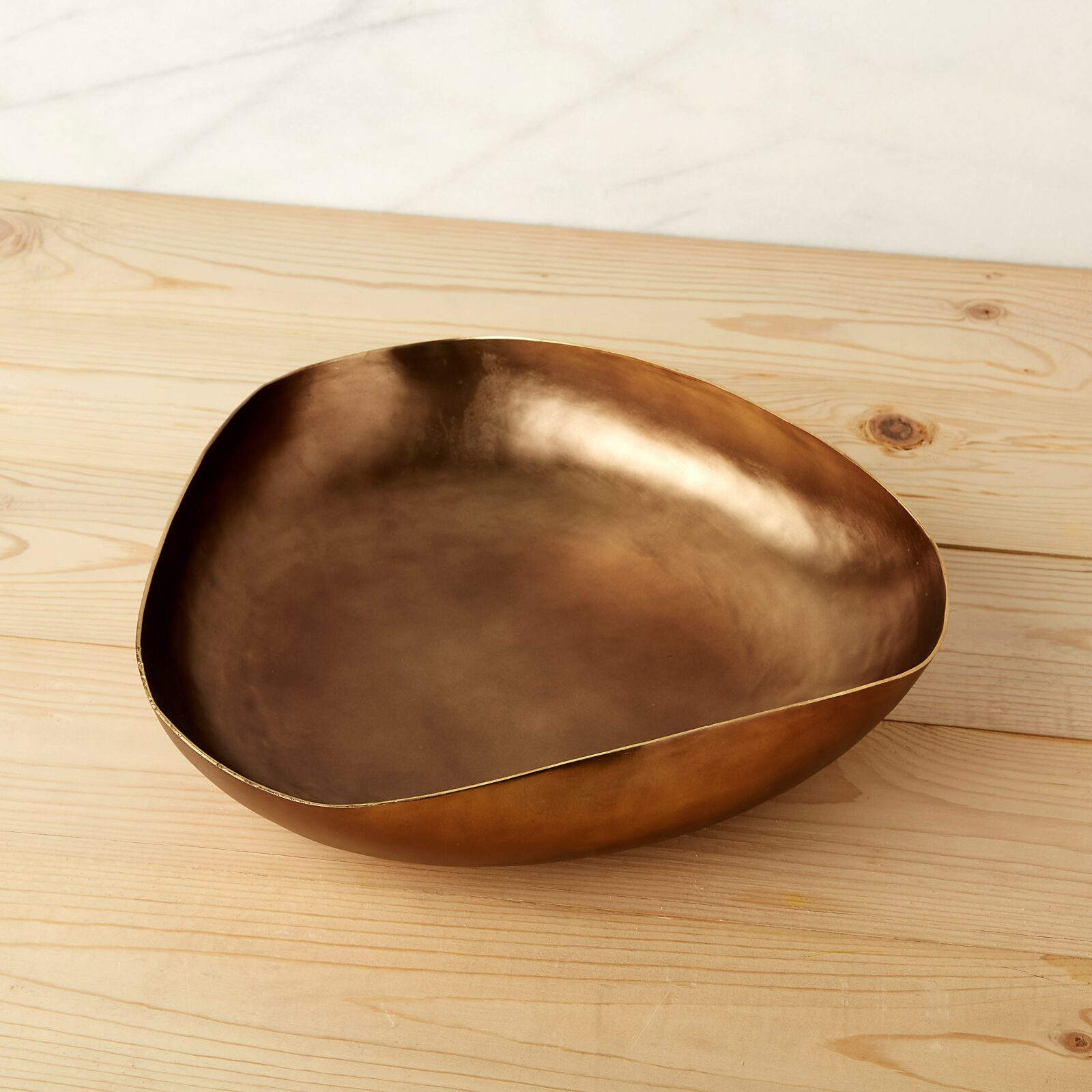 Bronze bowl on a wooden surface