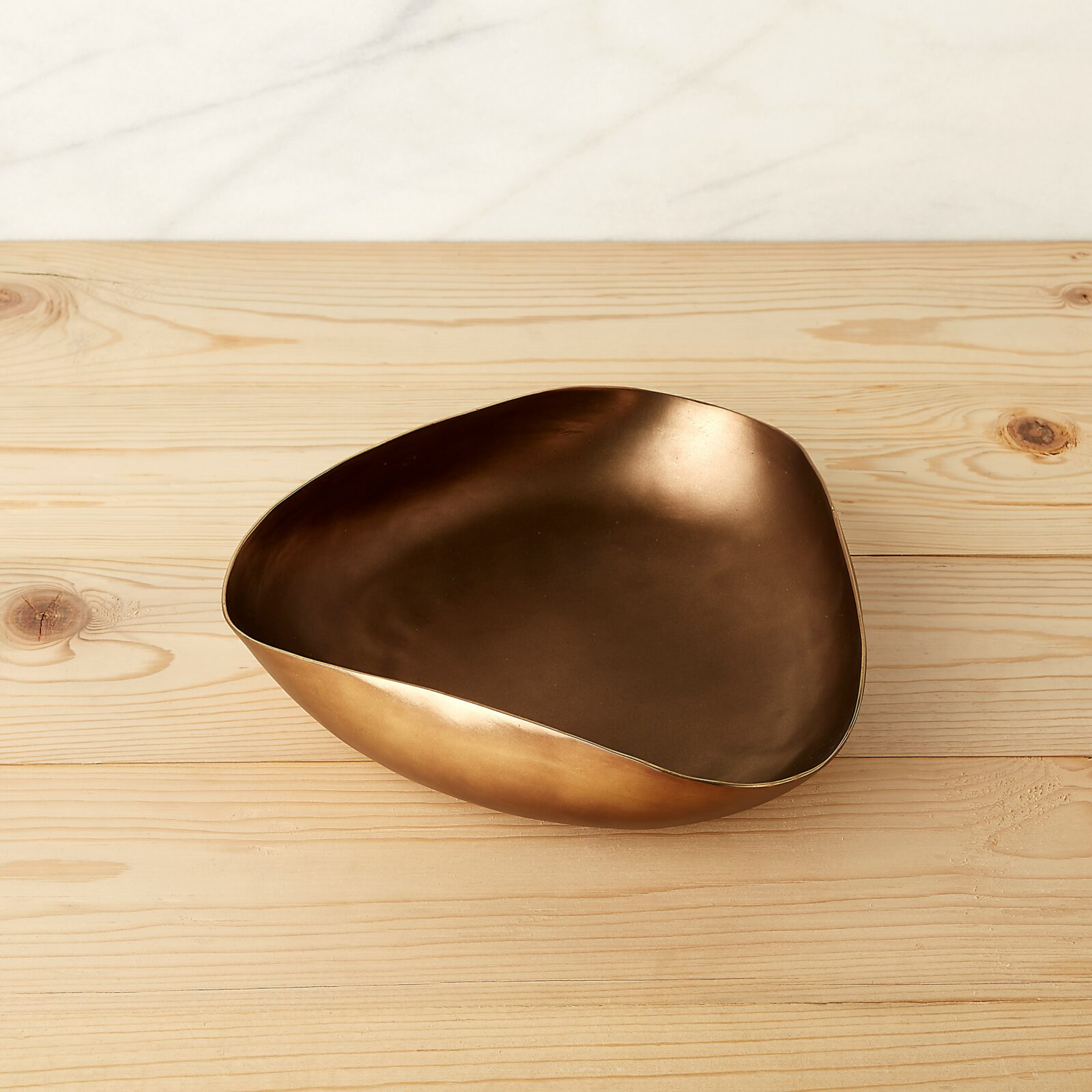Bronze bowl on a wooden surface