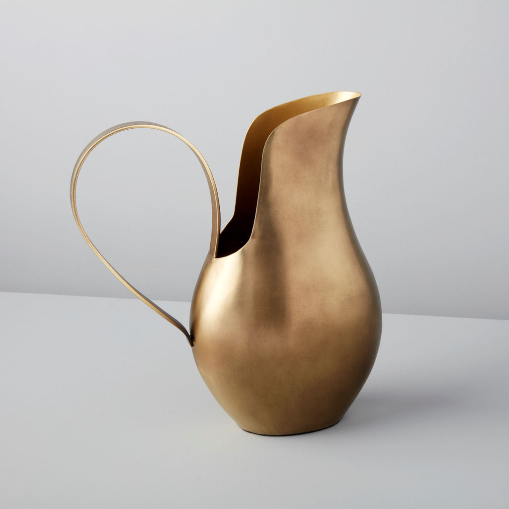 Bronze pitcher on a light gray background