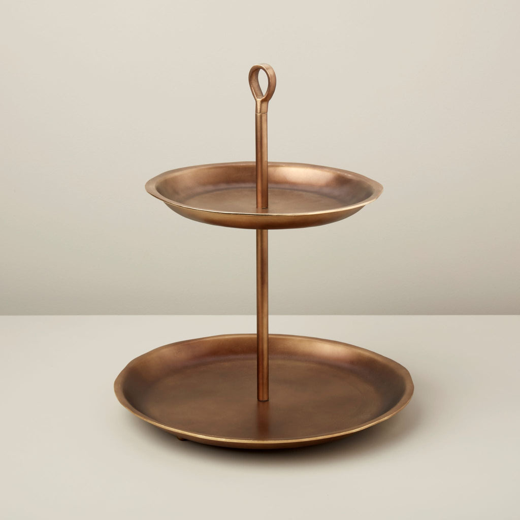 Bronze two-tiered stand on a light background
