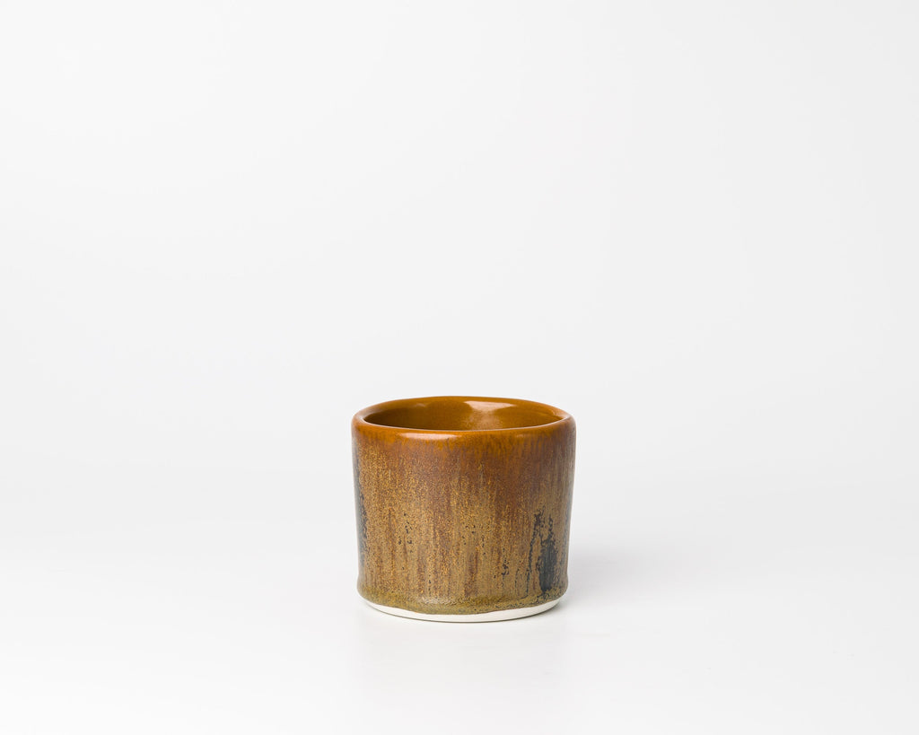 Brown ceramic cup on a white background