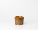 Brown ceramic cup on a white background