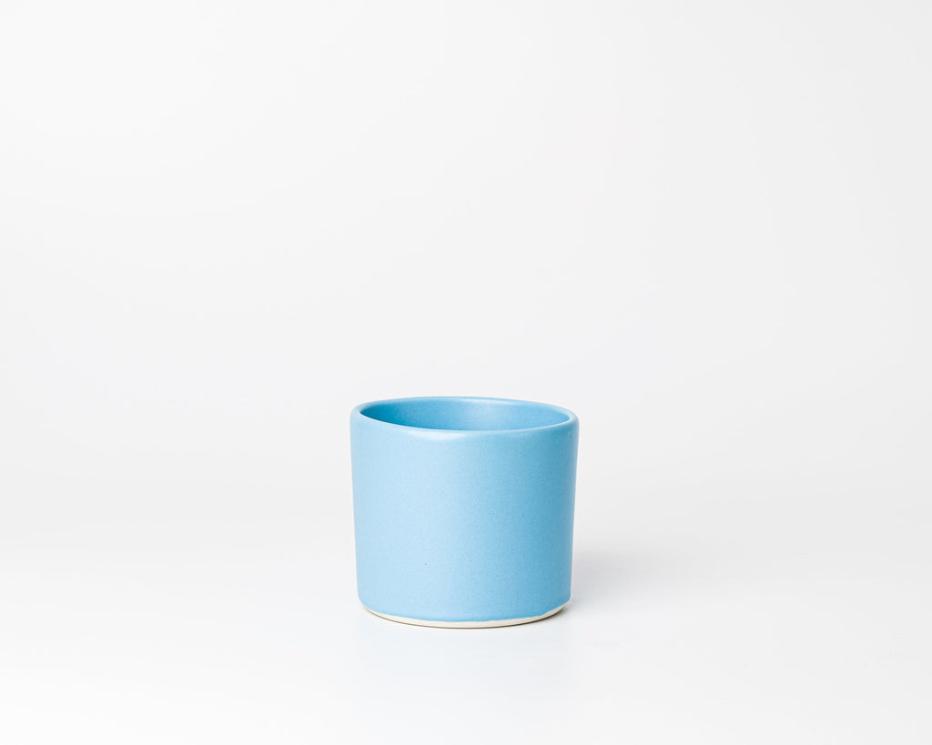 Blue ceramic cup on a white background
