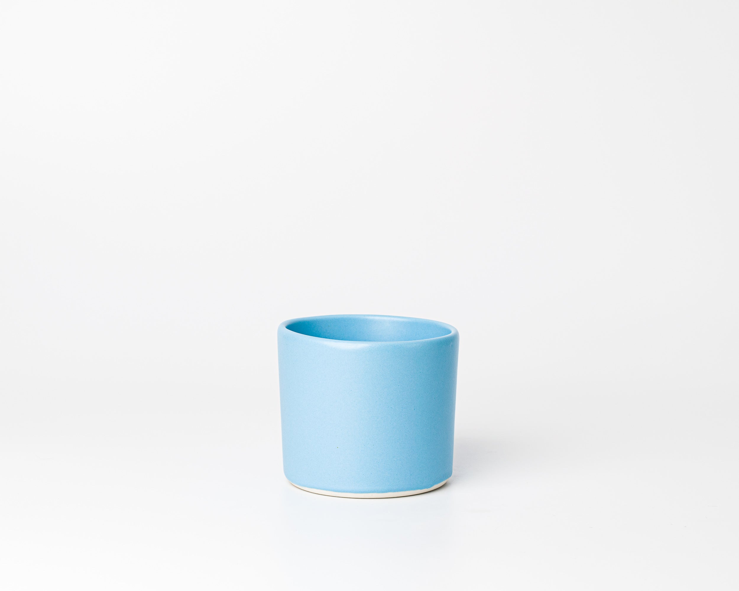Blue ceramic cup on a white background