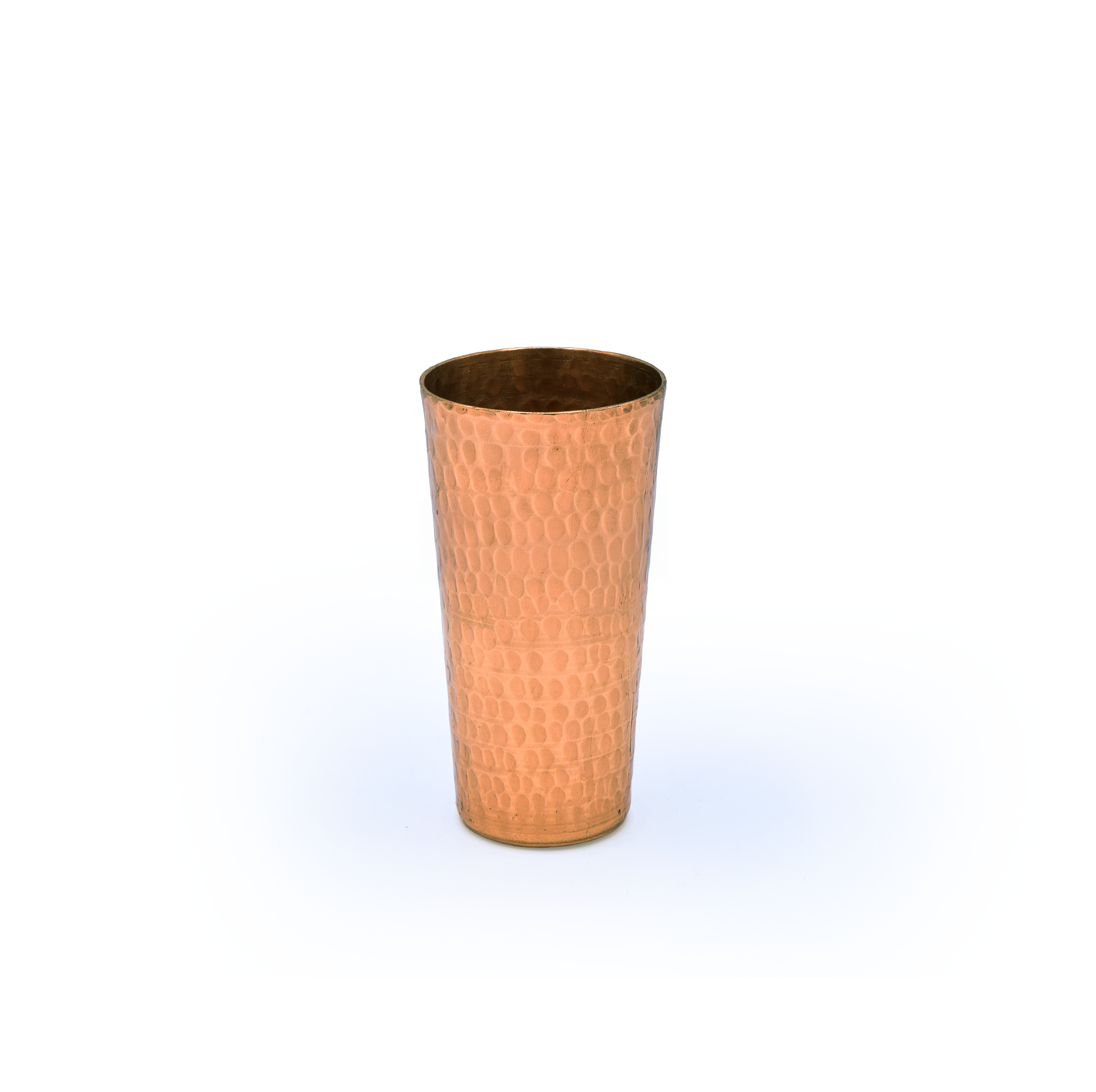 Copper tumbler with a textured surface on a white background