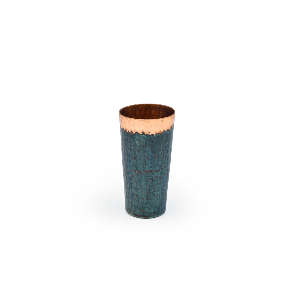 Tumbler with blue body and copper top on a white background