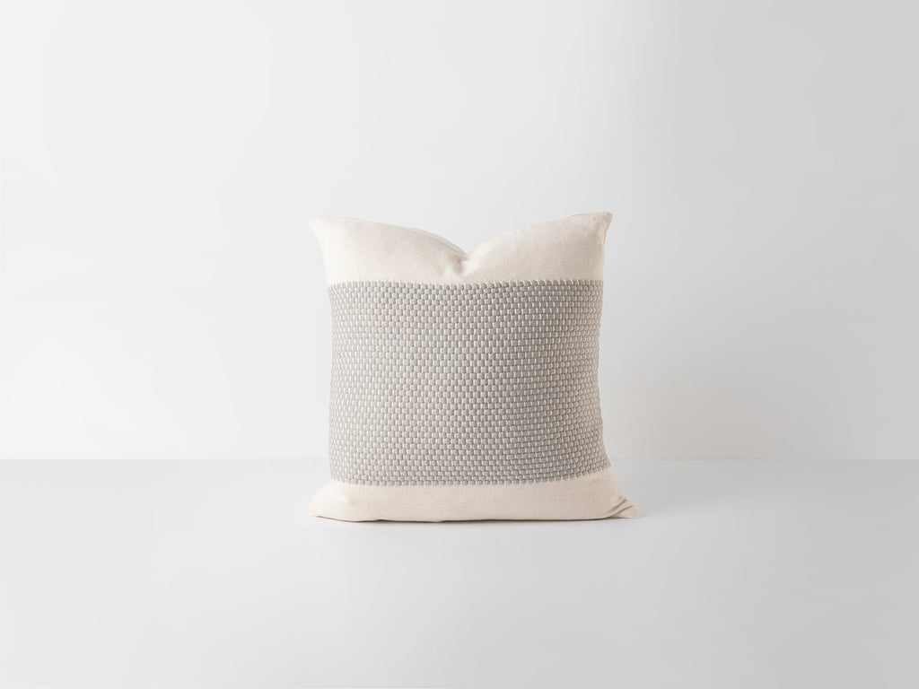 Decorative pillow with grey textured pattern on a white background