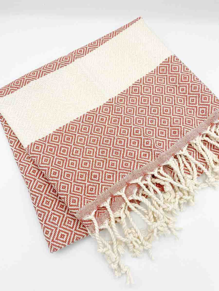 Chestnut brown diamond patterned hand towel with cream fringe on white background