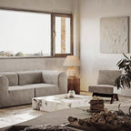 Modern living room with gray sofa, marble coffee table, and decorative elements.