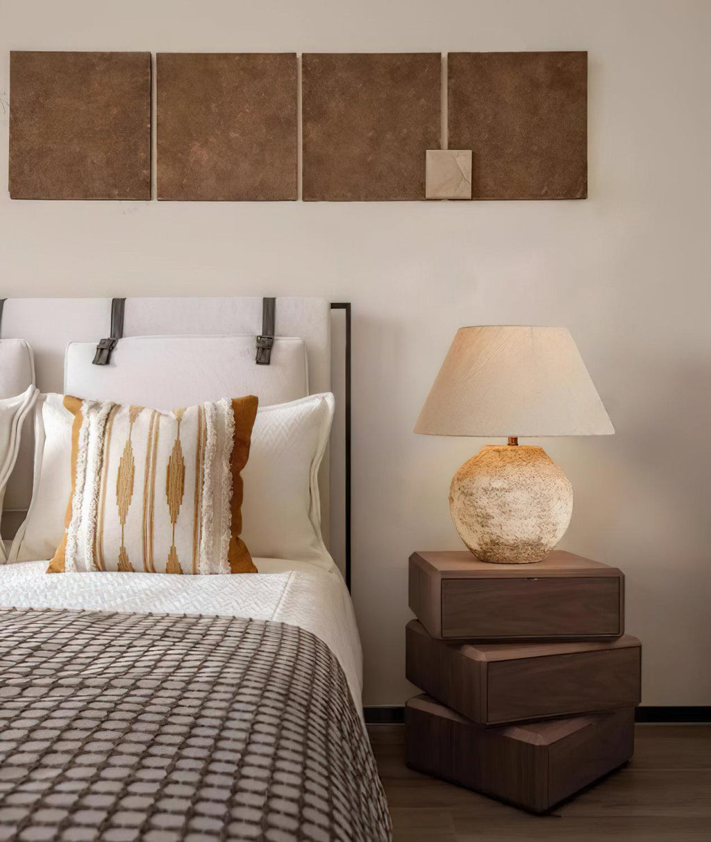 Bedroom with bed, lamp, and wall art