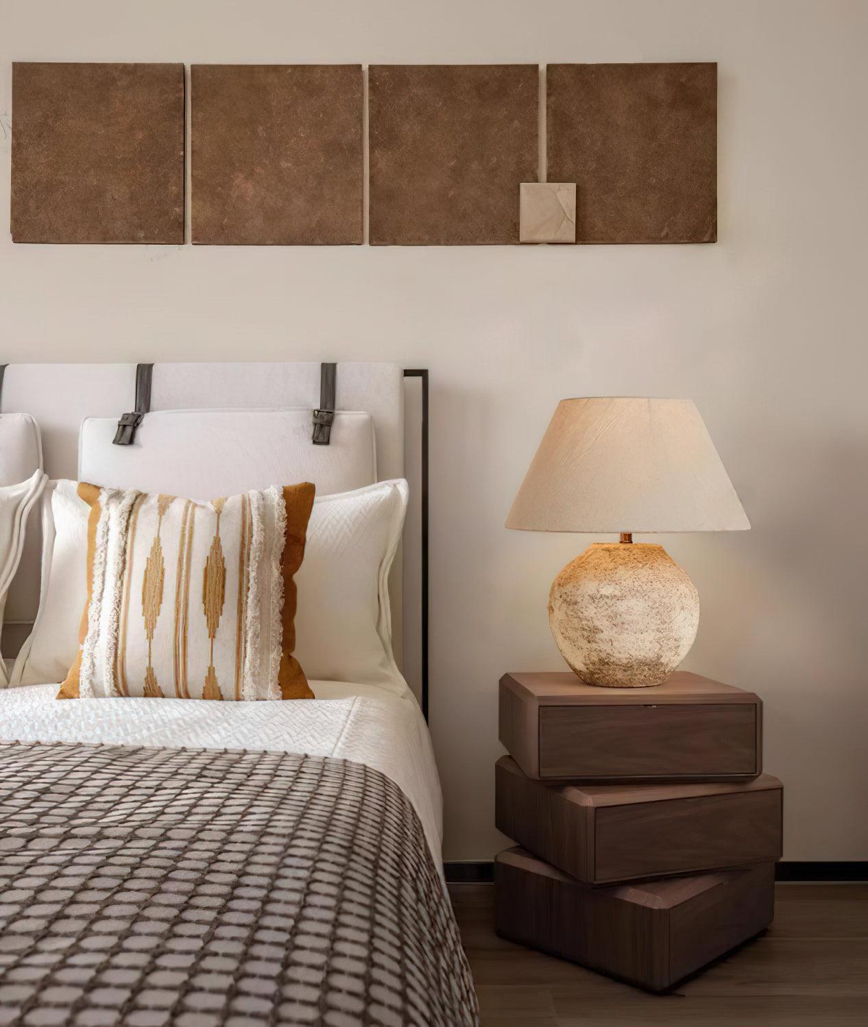 Bedroom with bed, lamp, and wall art