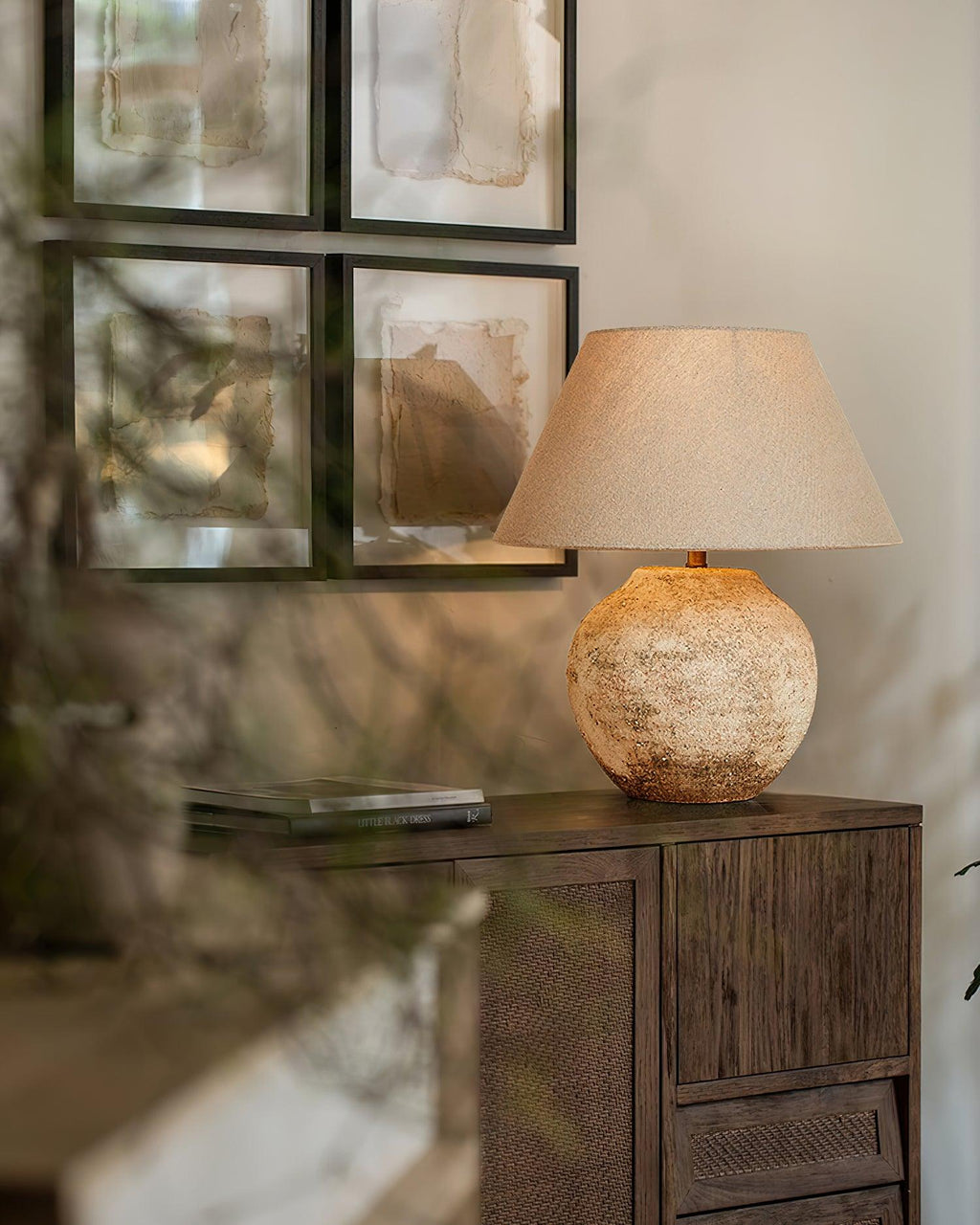 Decorative lamp on a wooden sideboard with abstract art in the background
