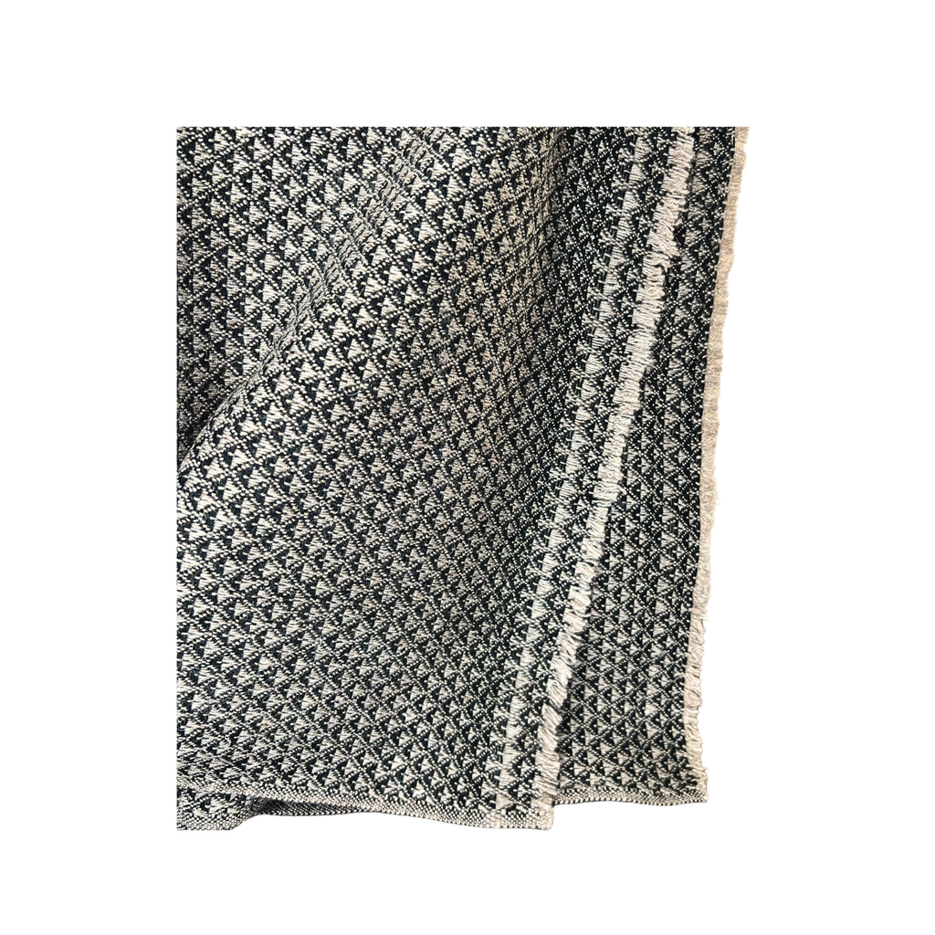 Textured blanket with geometric pattern on a white background