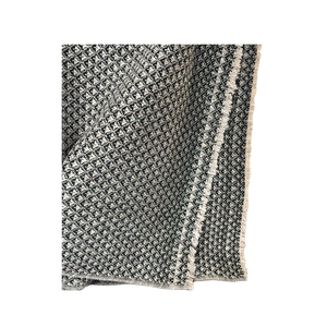 Textured blanket with geometric pattern on a white background
