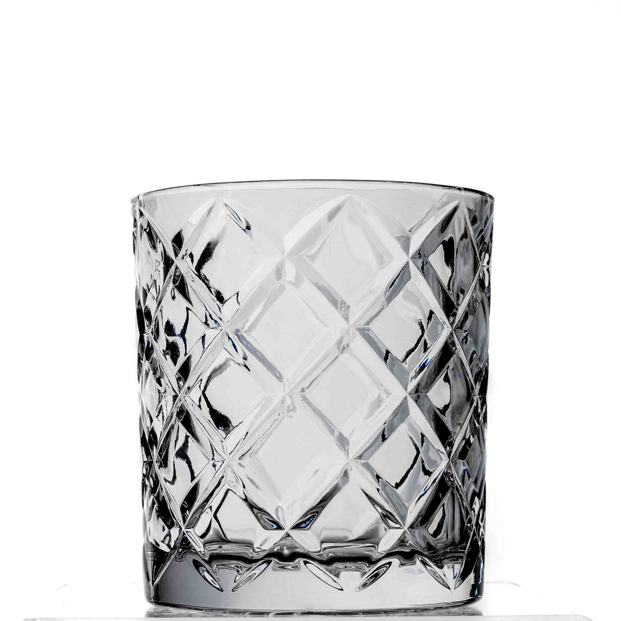 Clear glass tumbler with diamond pattern on a white background