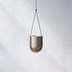 Beige hanging planter on a white background