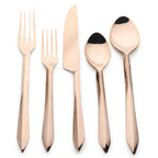 Set of rose gold cutlery on a white background