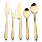 Set of gold cutlery on a white background