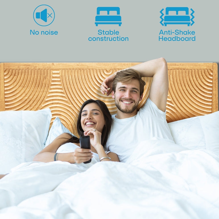 Couple lying in bed with a wooden headboard, featuring icons for no noise, stable construction, and anti-shake headboard.