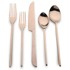 Rose gold cutlery set on a white background
