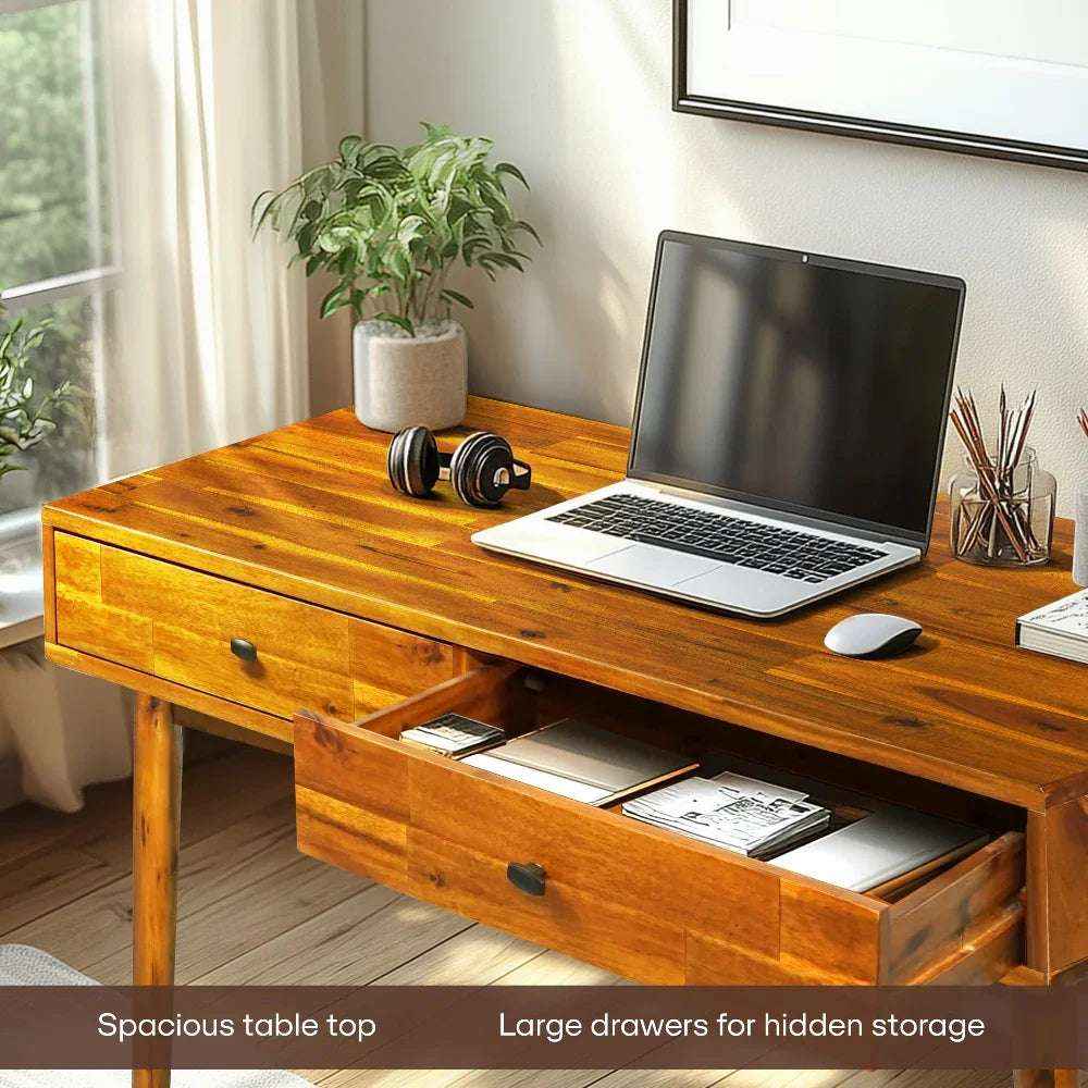 Wooden desk with laptop, mouse, and office supplies in a home office setting.