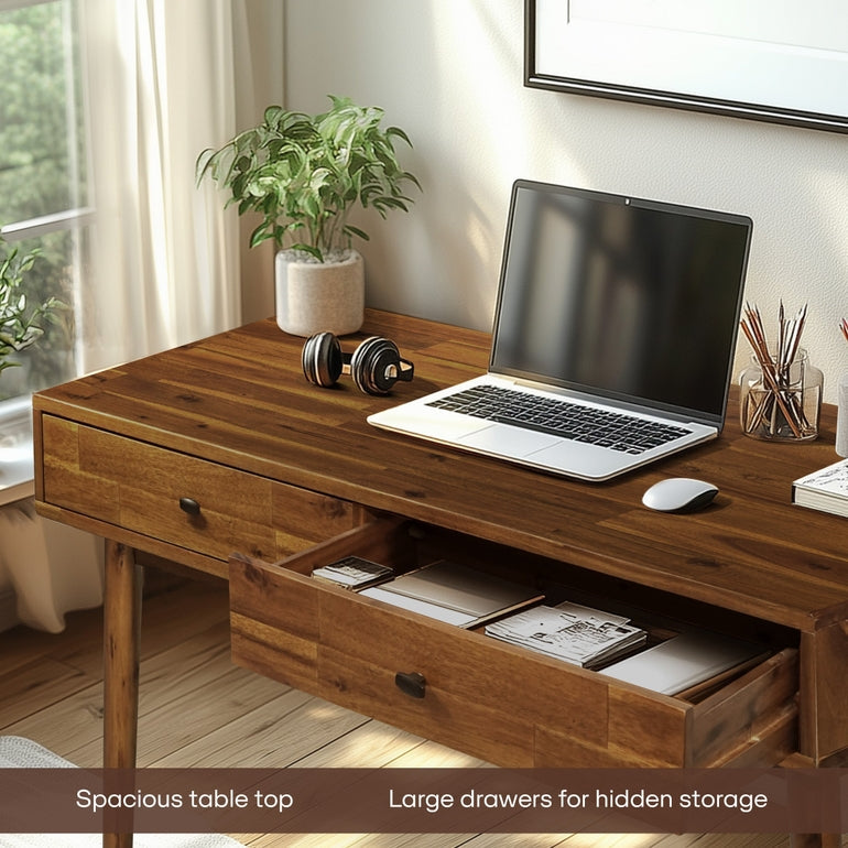 Wooden desk with laptop, mouse, and office supplies in a home office setting.