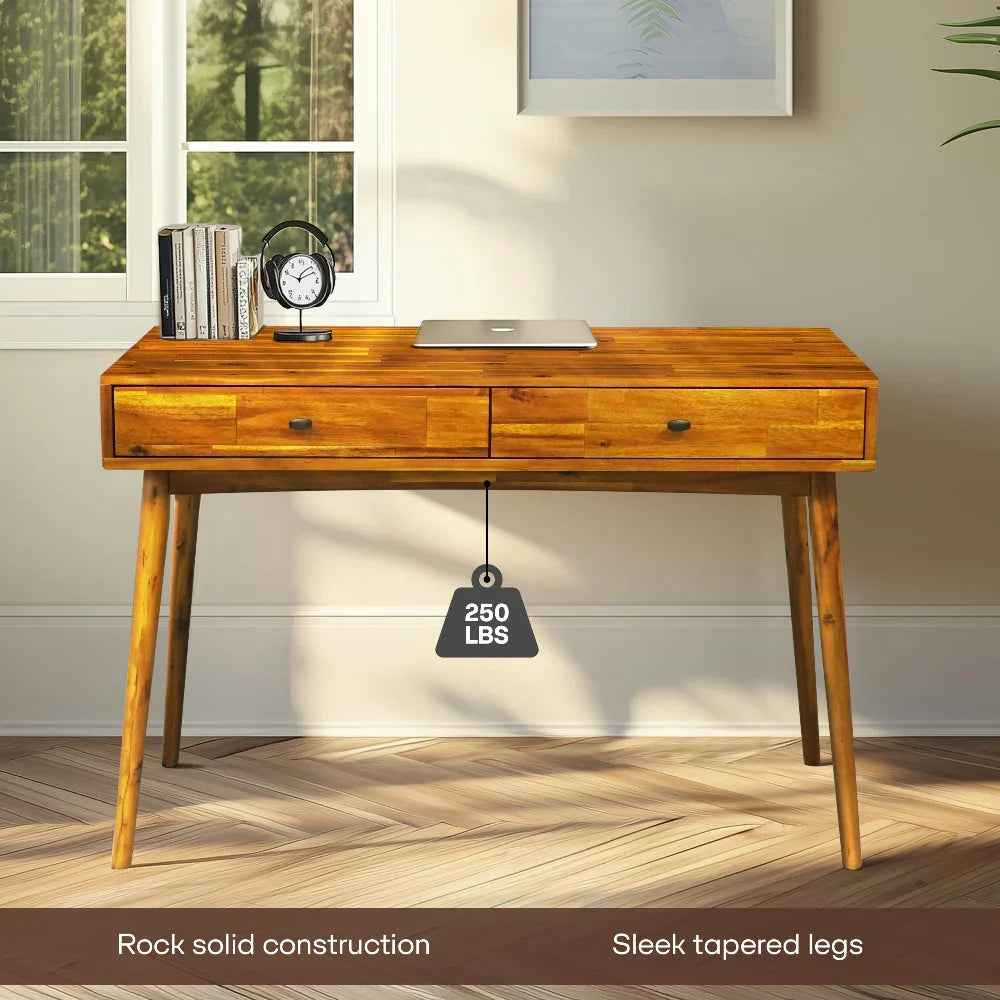 Wooden desk with two drawers in a room with a window and framed picture.
