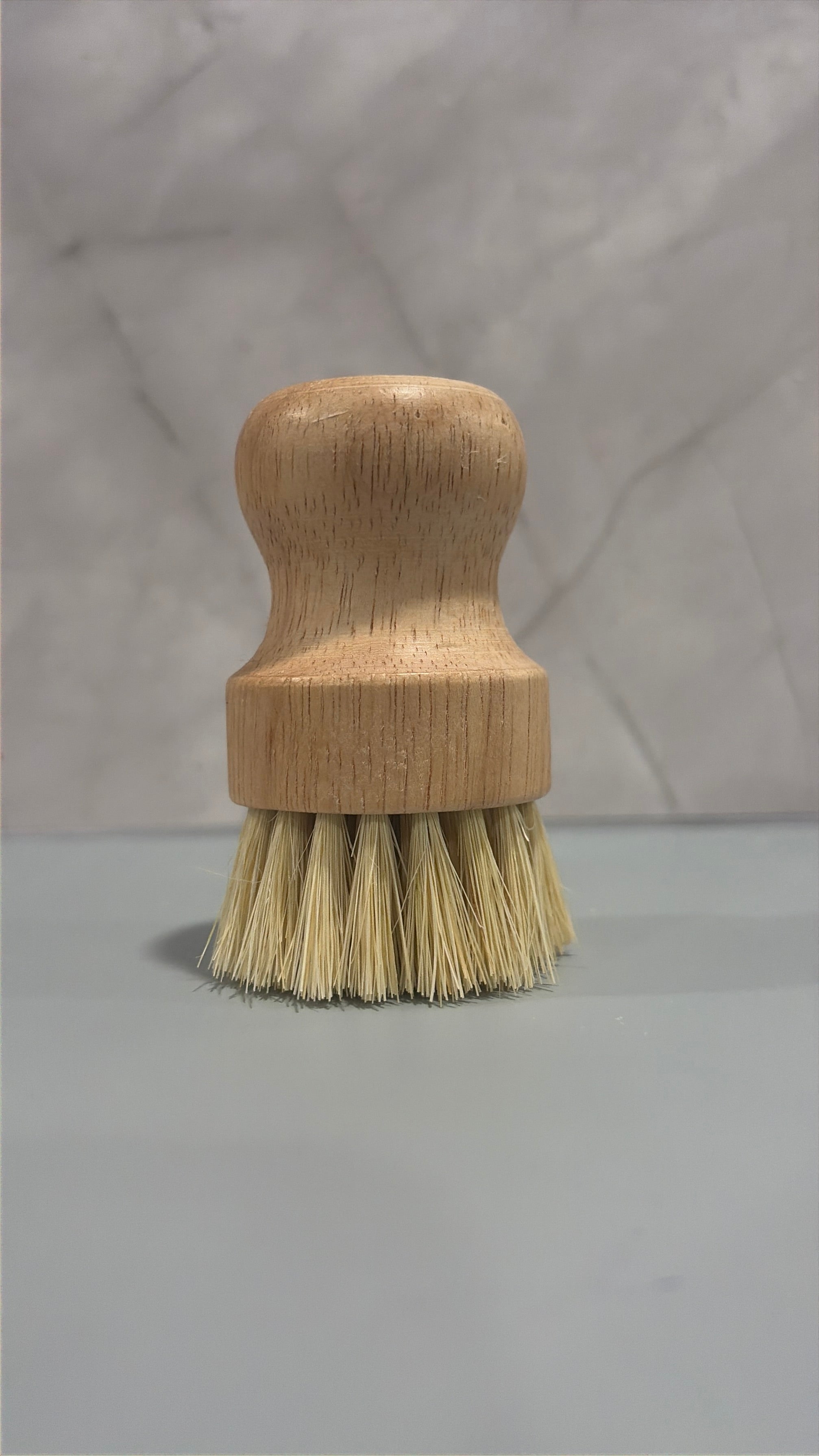 Wooden brush with bristles on a gray background