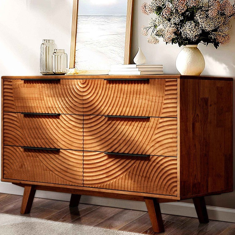 Wooden dresser with wavy grain design in a room setting