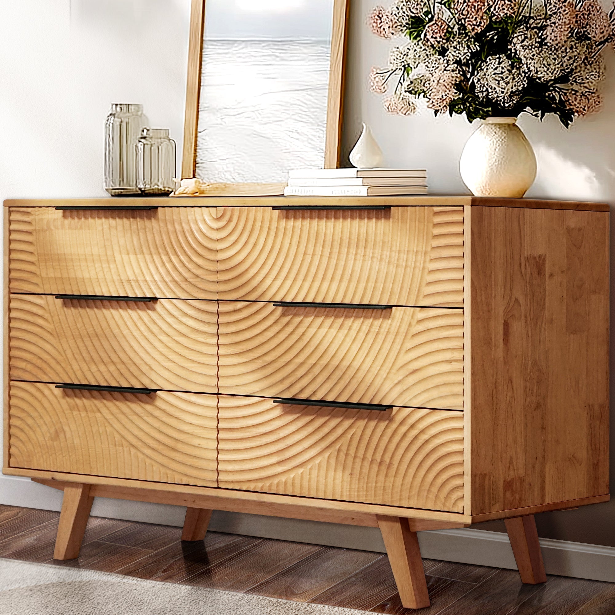 Wooden dresser with a floral arrangement and decorative items on top