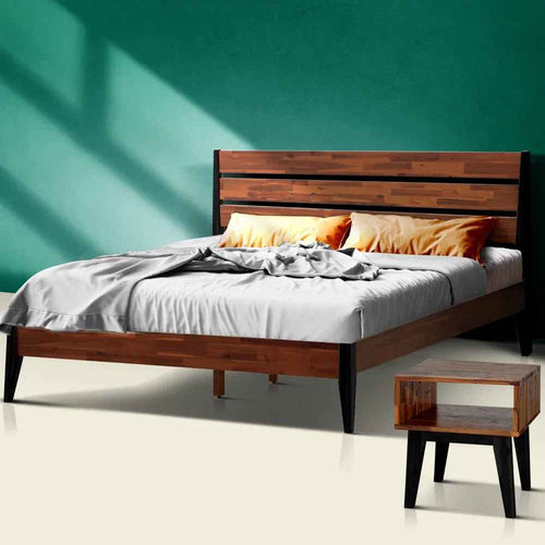 Wooden emery bed with bedding and a nightstand against a teal wall