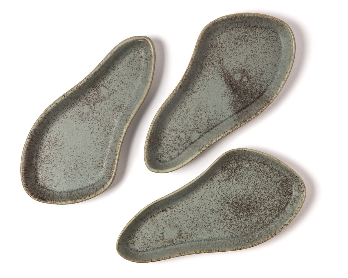 Three ceramic trays with a textured surface on a white background