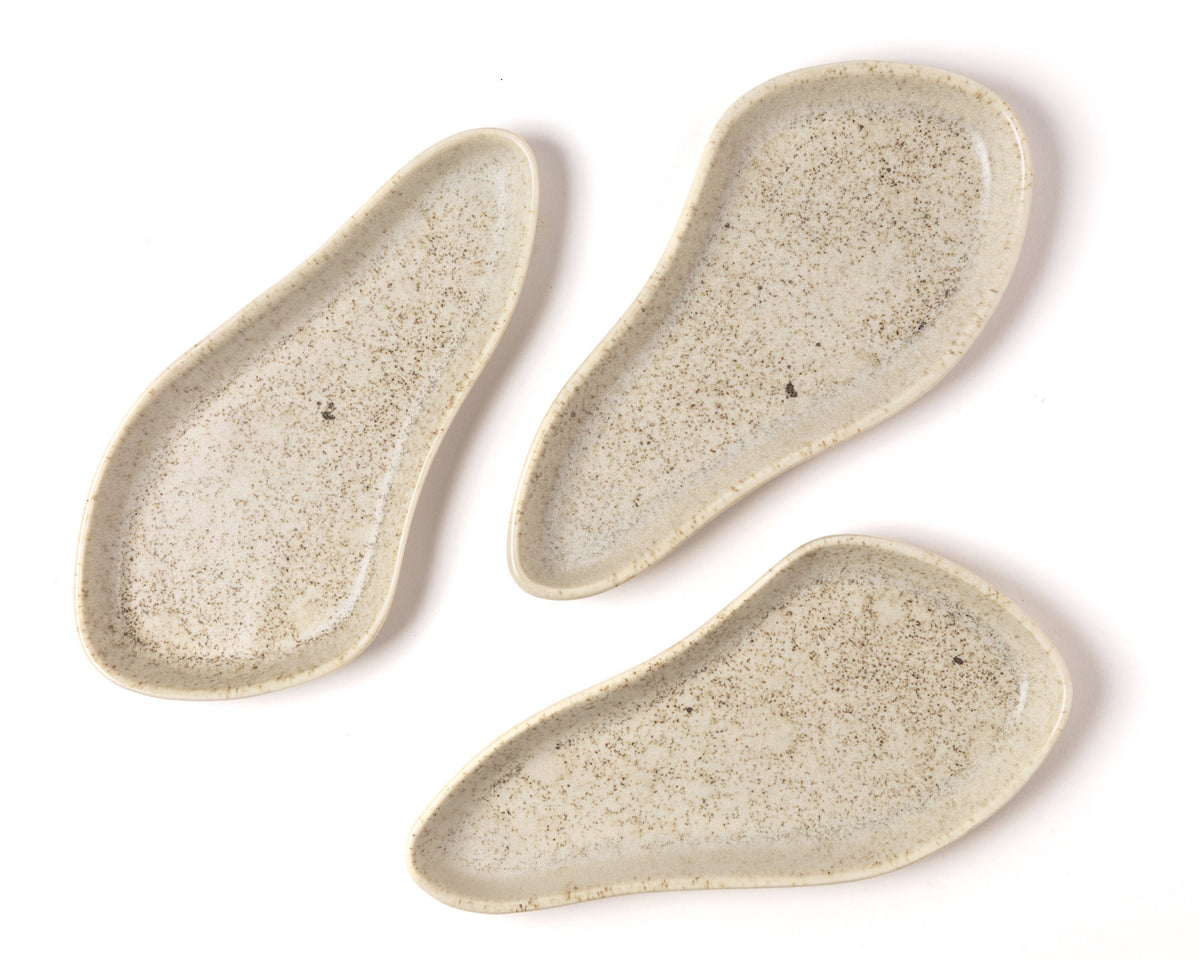 Three ceramic trays with a textured surface on a white background